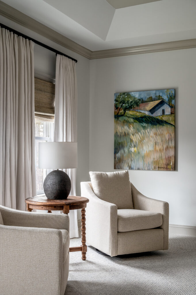 Seating area in bedroom with artwork