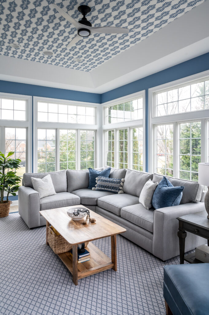 blue and white sunroom with furniture