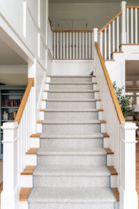 Interior Design in Maryland showing a custom stair runner, white and oak stairs, custom millwork.
