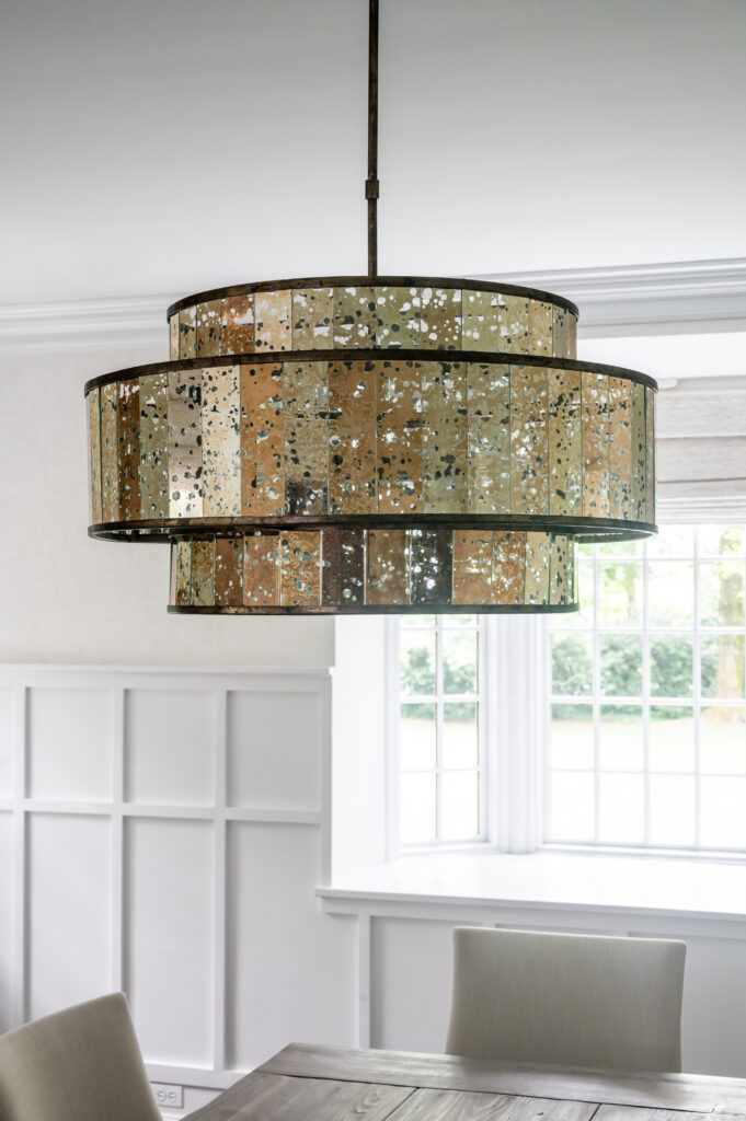 Beautiful dining room chandelier, custom wainscotting.