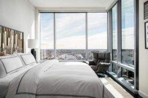 Masculine Primary bedroom in Baltimore City penthouse