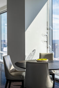 dining table with bubble light and sleek leather dining chairs