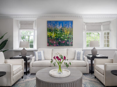 Elegant Parlor used for entertaining guests. Adorned with light furnishings and a bold, colorful painting