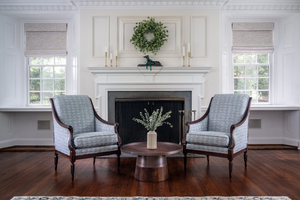 Two chairs in front of fireplace. Loyola greyhound