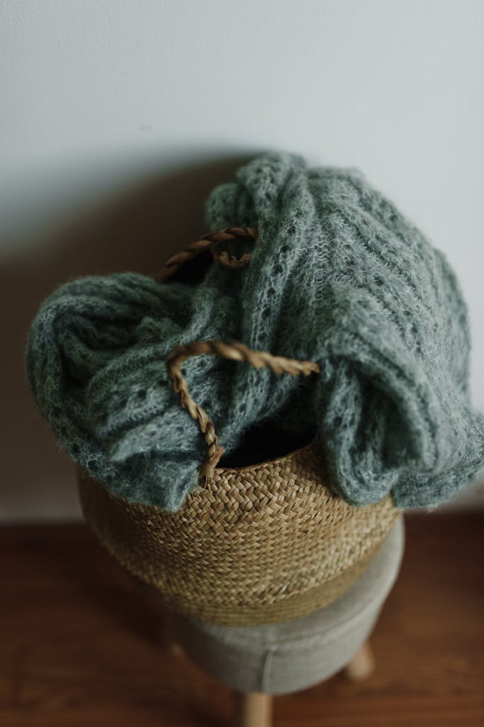 Knitted Sweater on Top of a Woven Basket