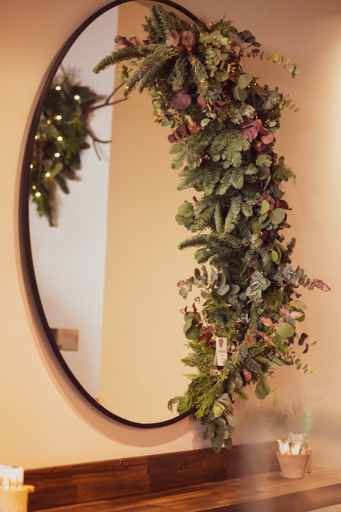 Oval mirror with hanging greenery, creating a festive indoor atmosphere.