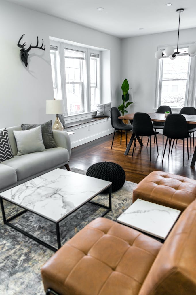 Stylish living and dining area with elegant table, cozy chairs, and modern decor.