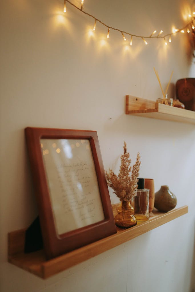 Warm and rustic autumn-themed shelf with fairy lights setting a cozy mood.