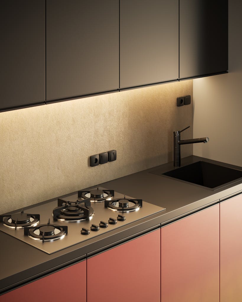 A modern kitchen interior featuring a sleek countertop, gas stove, and stainless steel faucet.
