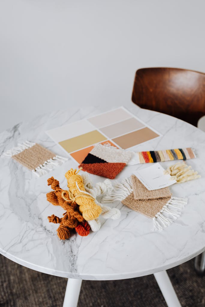 Handmade textile and color samples on a marble table in a modern setting.