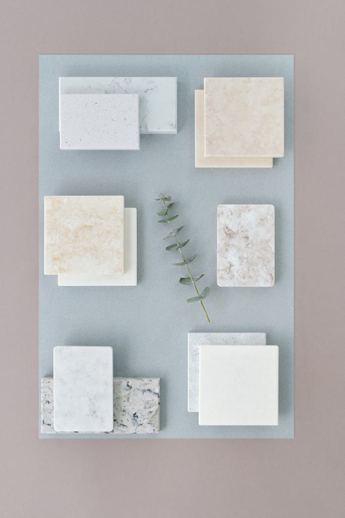 Marble and eucalyptus displayed in a minimalist flat lay on a neutral background.