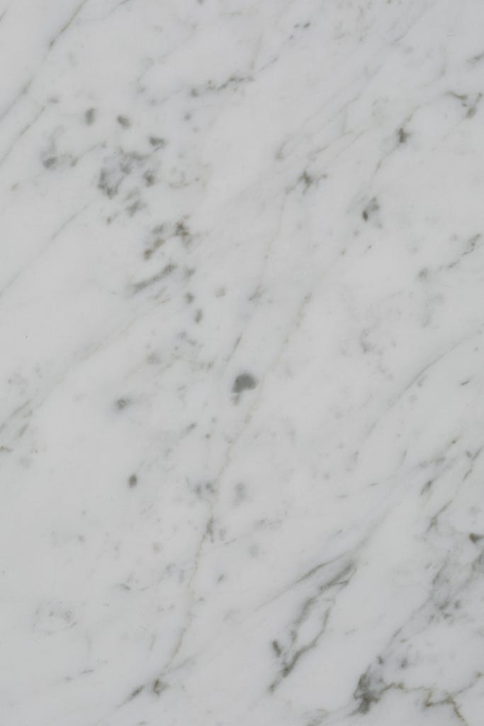 Vertical close-up showcasing white marble's natural texture and patterns.